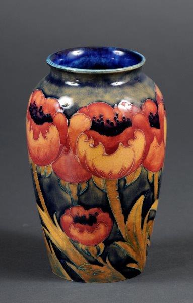 alt="poppy vase with blue background"
