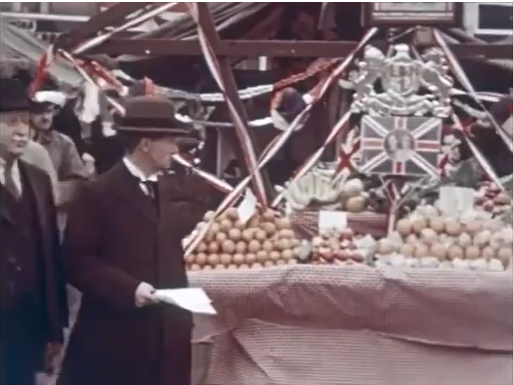 A screenshot from a video showing a fruit and veg stall on the market