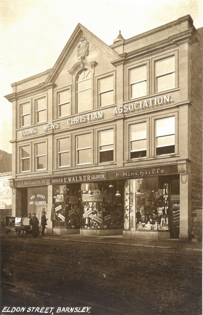 Photograph of the new YMCA building in Eldon Street c.1909. It has three shops on the ground floor and a sign between the first and second floor windows that says 'Young Men's Christian Association'